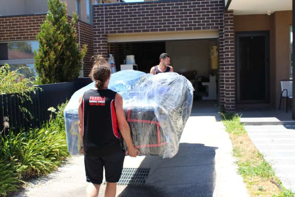 how long does it take to move house – removal truck loaded with furniture and boxes, with packed cartons staged on the driveway ready for loading and transport
